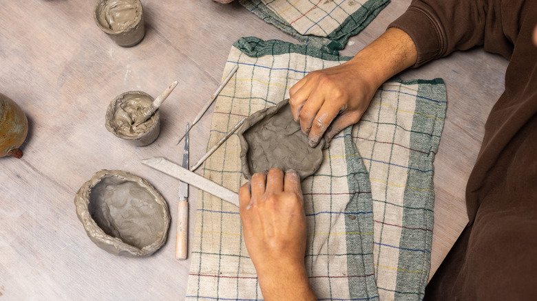 someone working on air dry modeling clay