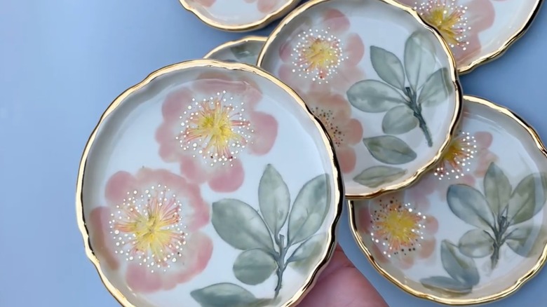 DIY ceramic plates made with pressed flowers and leaves and colorful underglaze