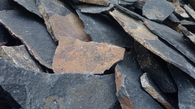 A stack of rough andesite slabs ready for construction use
