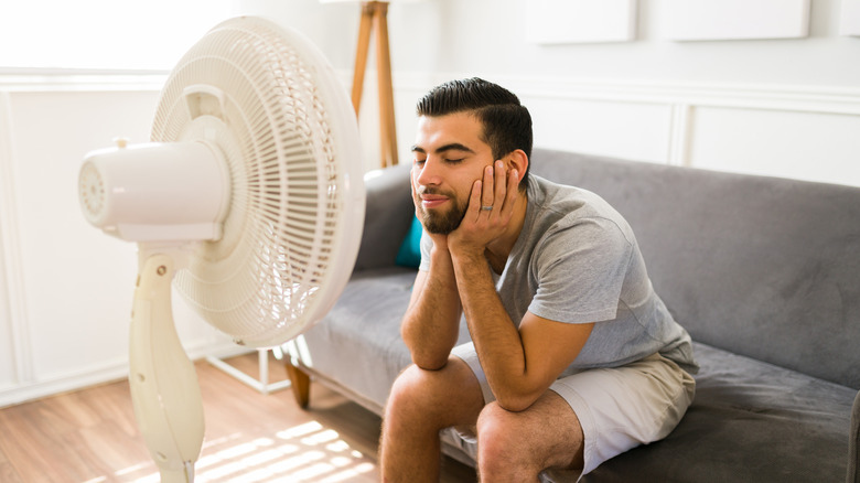 man in front of fan