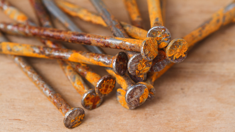 rusty nails on wooden background