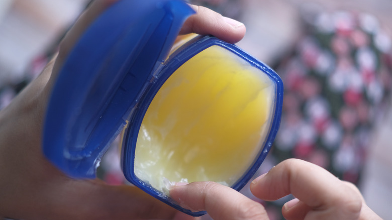 Woman using jar of Vaseline