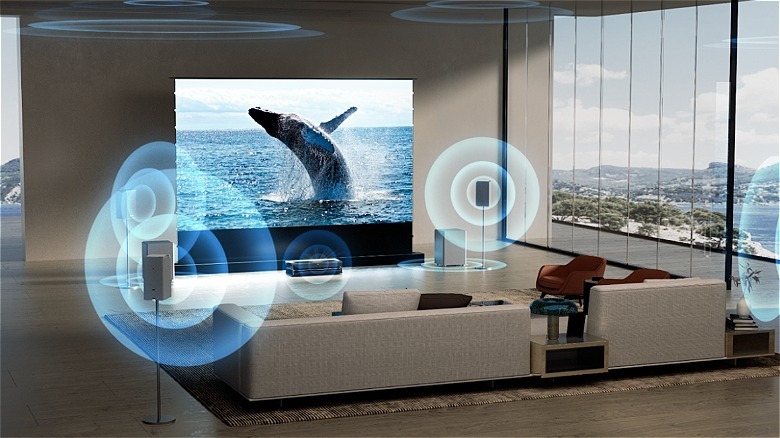 Living room with whale on screen and AWOL Thunderbeat Wireless surround sound speakers