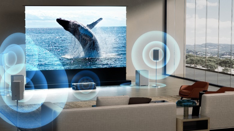 Living room with whale on screen and AWOL Thunderbeat Wireless surround sound speakers