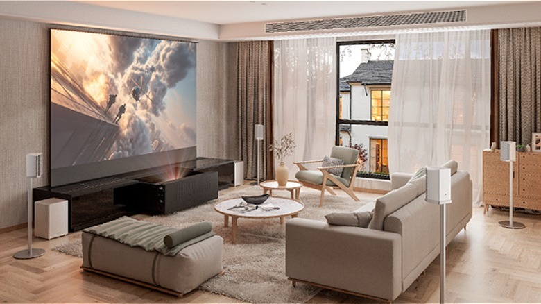 Modern living room with AWOL projector showing an action movie