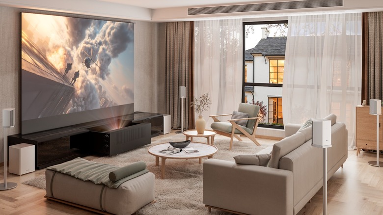 AWOL Vision projector and screen in modern neutral living room with speakers