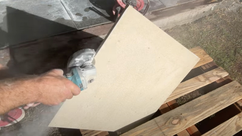 YouTuber tidybrikslandscaping uses a bullnose attachment in use on a porcelain tile