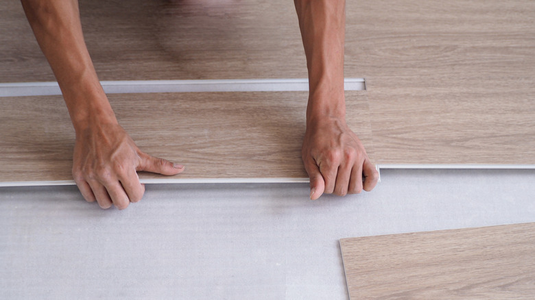 hands installing LVP