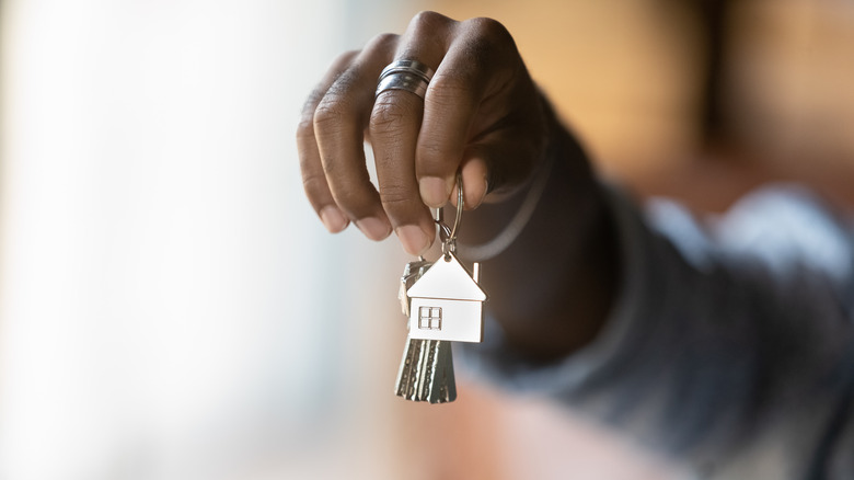 Hand holding house keys