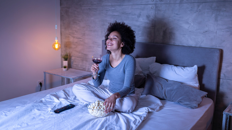 Woman watching TV in bed 