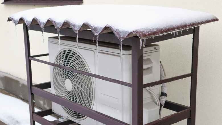 One version of a cover designed to keep snow off a heat pump