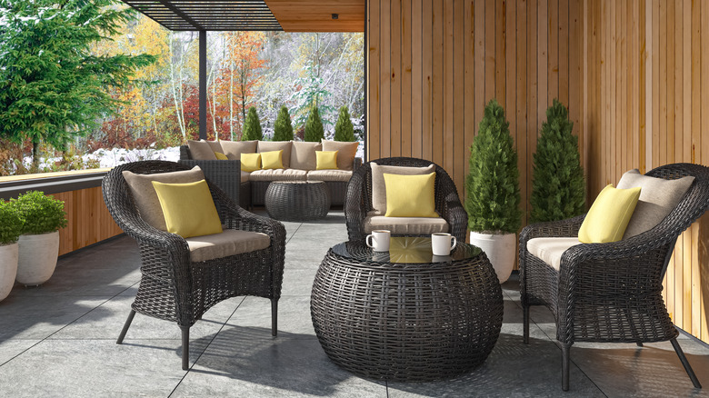 A black rattan furniture set outside