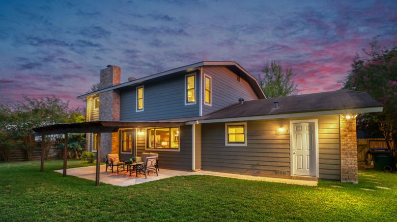 A house and backyard patio at sunset