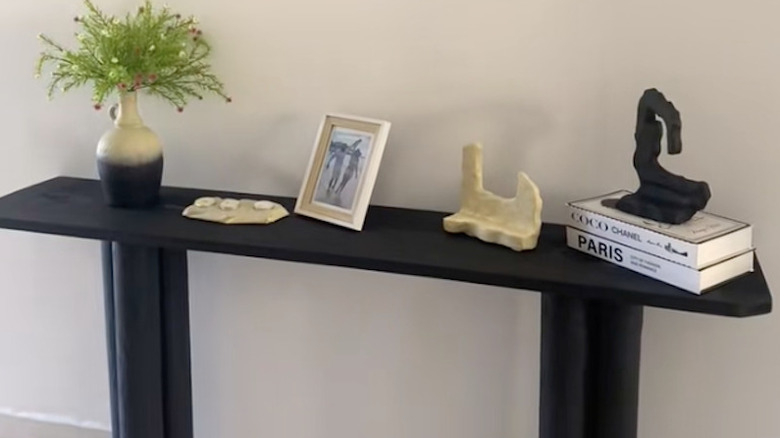 An entryway table made from PVC pipe and scrap wood