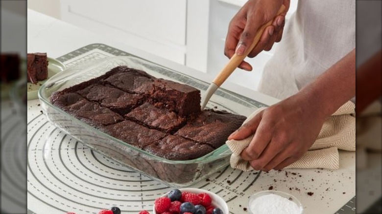person removing slice of dessert from Amazon Basics glass dish
