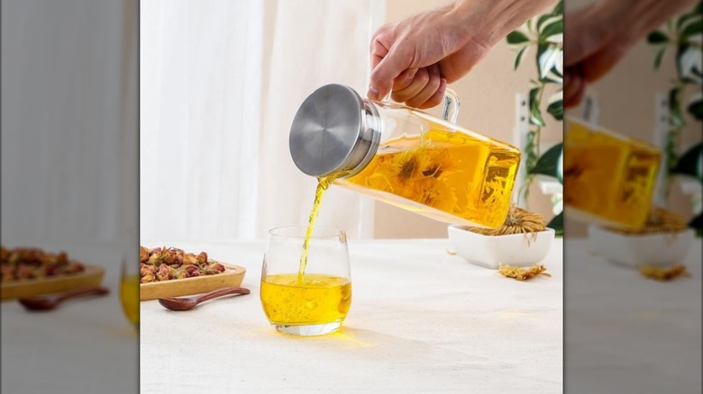 person pouring drink from NETANY pitcher