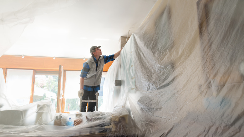 covering furniture and walls with tarp