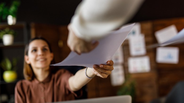 woman accepting papers
