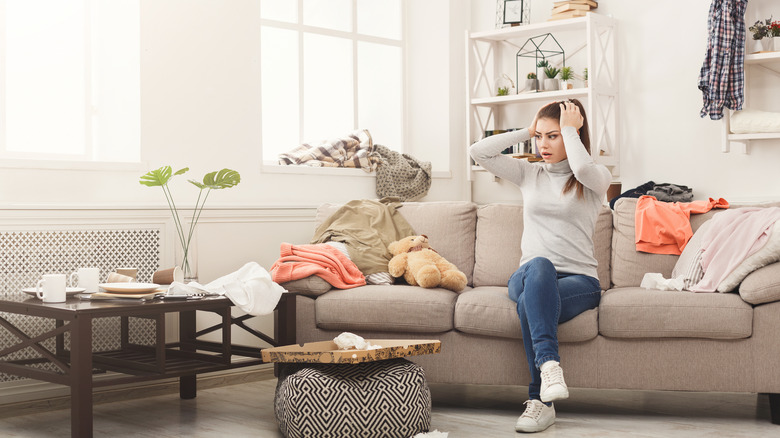 woman in cluttered room