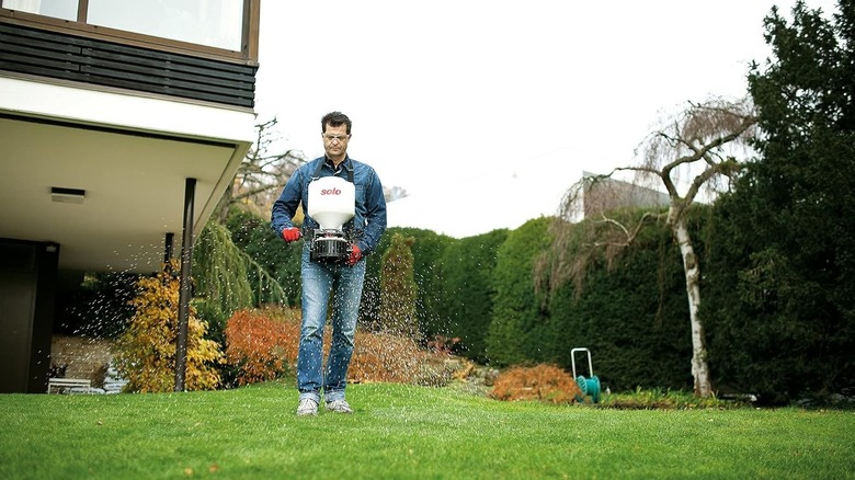 Man using a wearable broadcast spreader