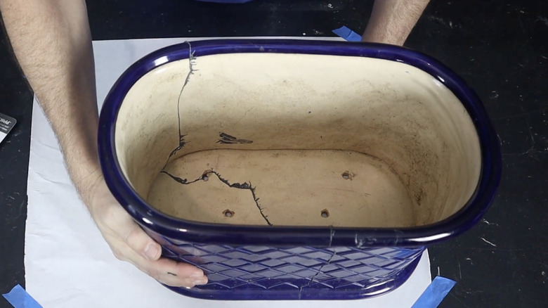 Repairing a broken planter with J-B Weld.