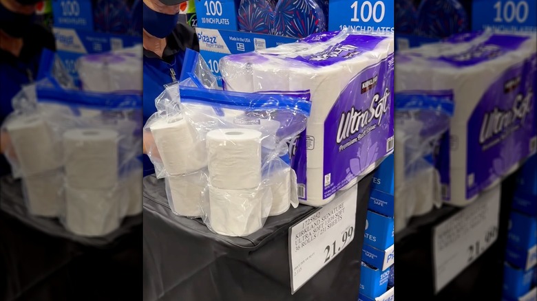 Costco sample table filled with toilet paper samples.