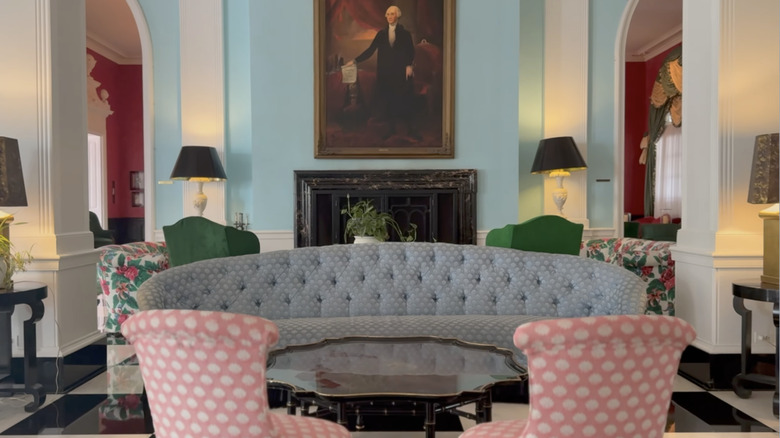 The Greenbrier's upper lobby with pink polka dot chairs, blue sofa, and statement coffee table.