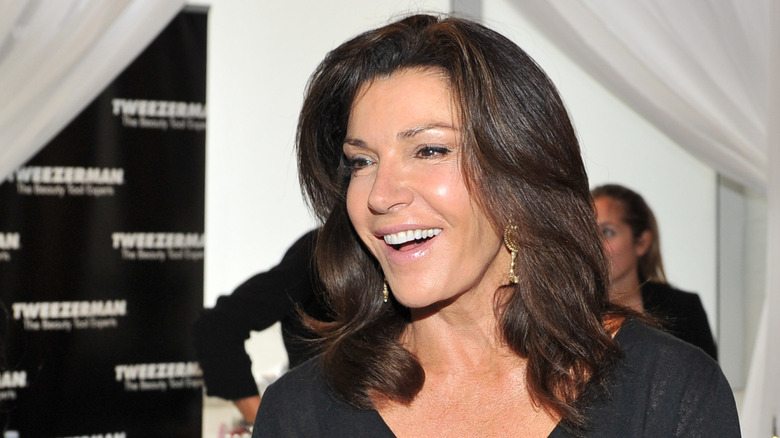 Hilary Farr smiling while being interviewed at an event