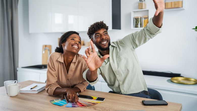 Couple discussing future designs at kitchen table