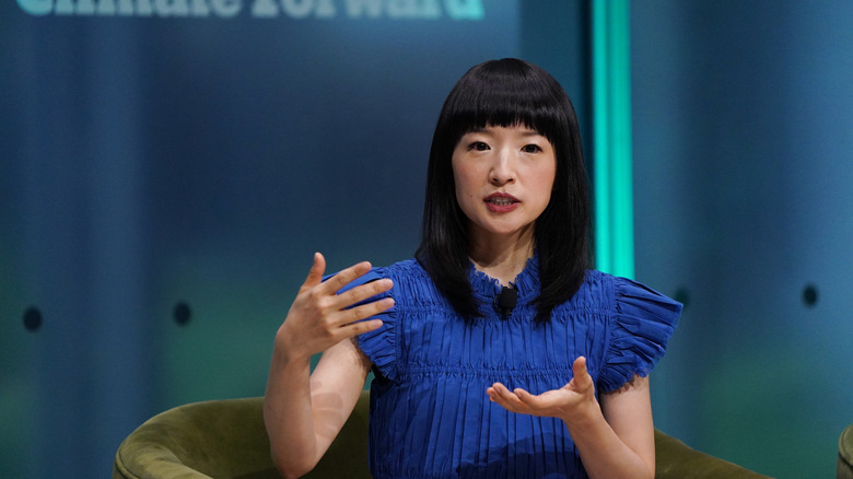 Marie Kondo in a blue shirt, speaking on a panel