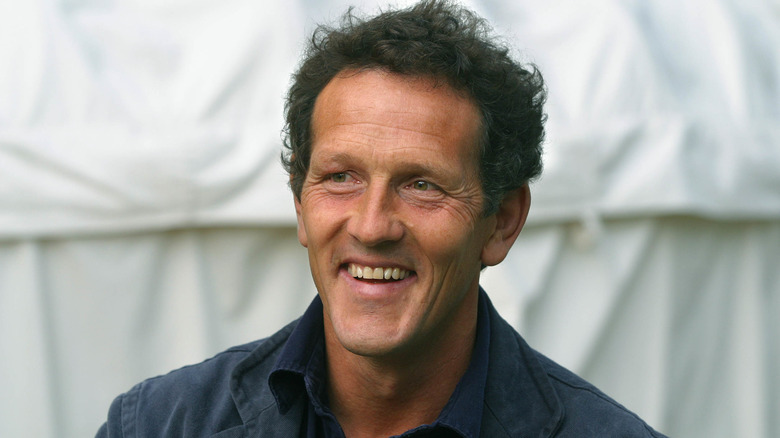 Monty Don smiling in front of a white tent