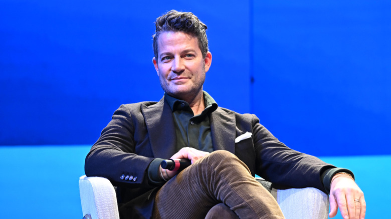 Nate Berkus sitting on stage with a microphone in hand