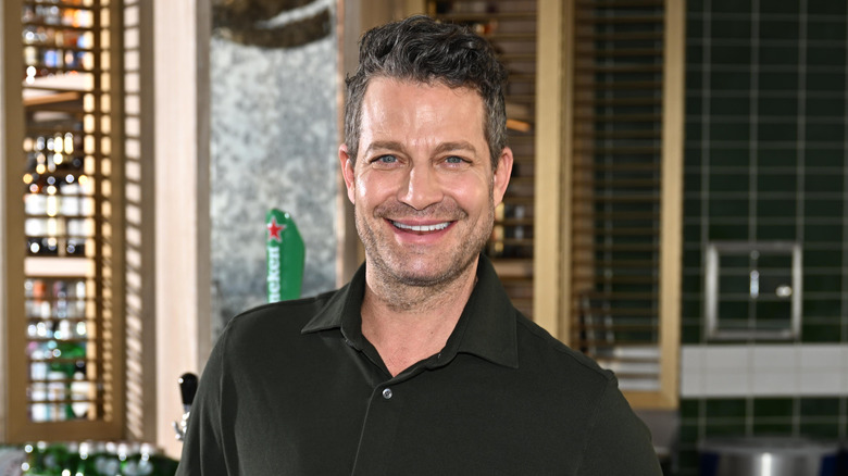 Nate Berkus smiling with a bar in the background