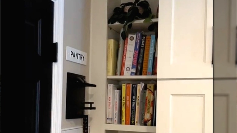 Books stored in alcove near Pantry sign