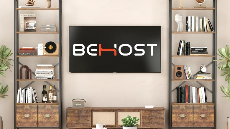 Two brown bookshelves placed on either side of a TV