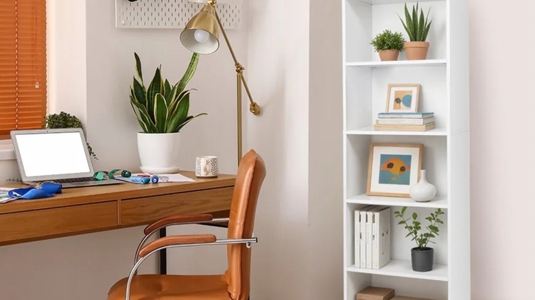 A small white bookshelf near a workstation