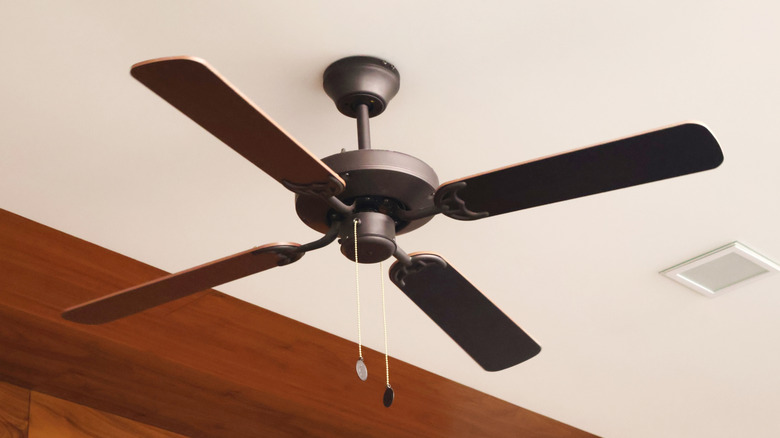 Modern four-blade wood ceiling fan on high ceiling