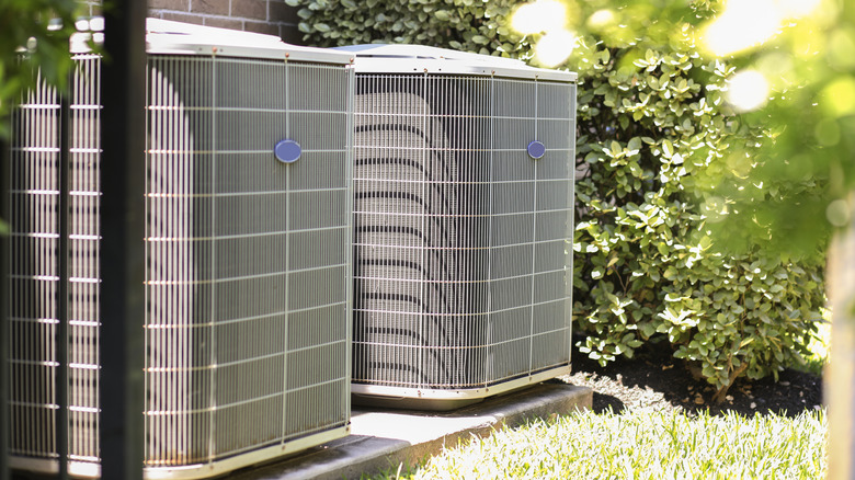 Double AC units outside house in summer