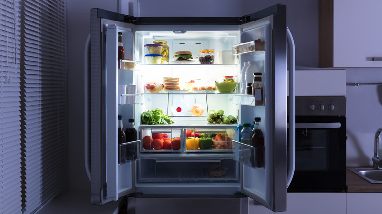 An open refrigerator in a kitchen