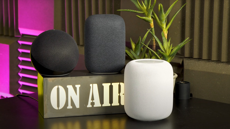 Smart home speakers from Amazon, Google, and Apple on podcaster table