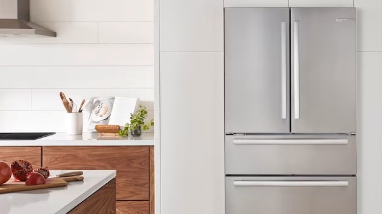 Luxurious and expensive Bosch Fridge nestled in kitchen alcove with dishes