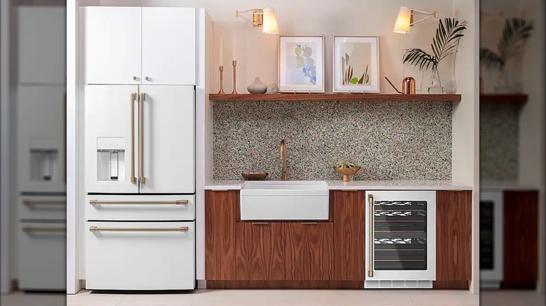 Personalized white cafe refrigerator with copper finish handles in decorated kitchen