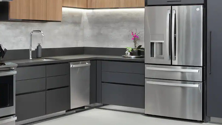 Luxury GE Profile refrigerator with multiple doors and drawers in corner of modern kitchen