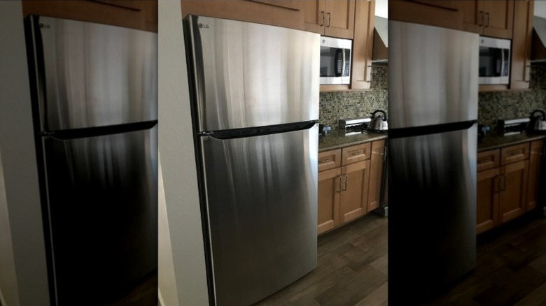 LG refrigerator in traditional wood and tile kitchen