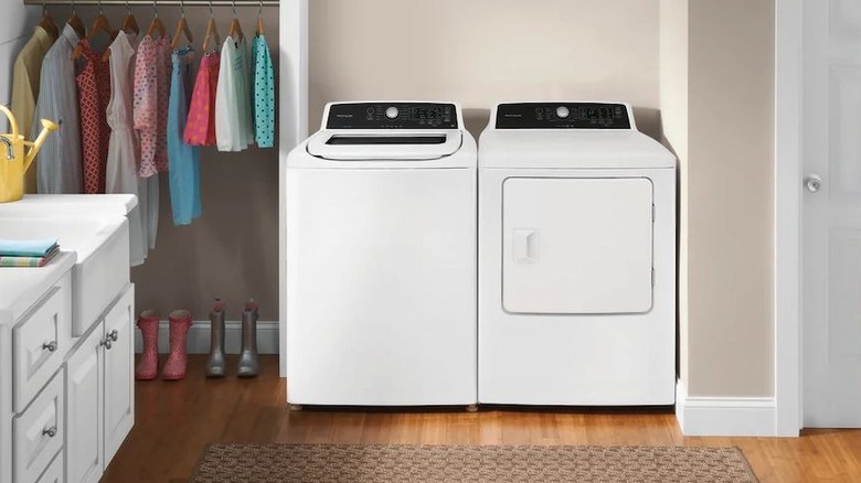 Frigidaire washer and dryer set in staged brightly lit mid century modern room