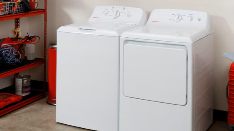 Ge Hotpoint washing machine in garage space beside utility shelves