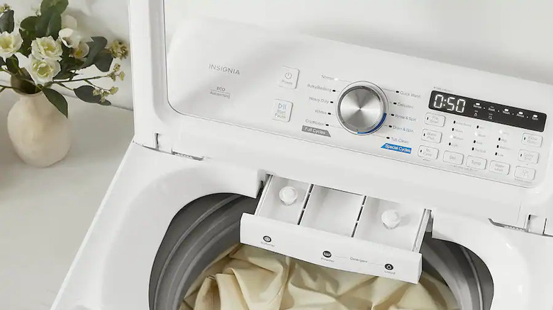 Close-up of Insignia top-load washing machine with controls and dispensers