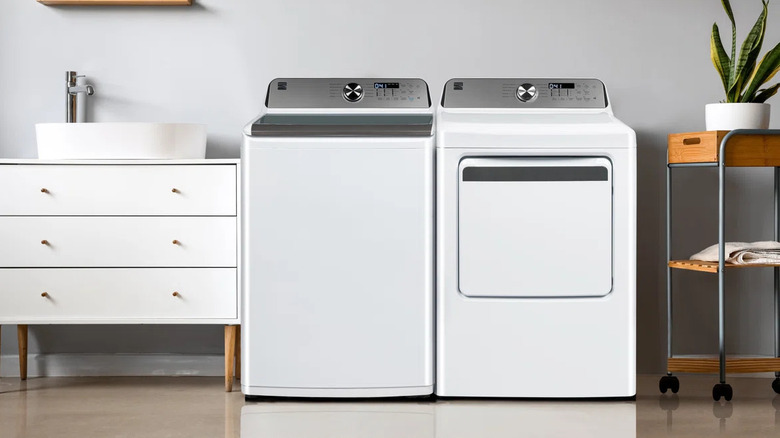 Kenmore washing machine beside staged sink and dryer
