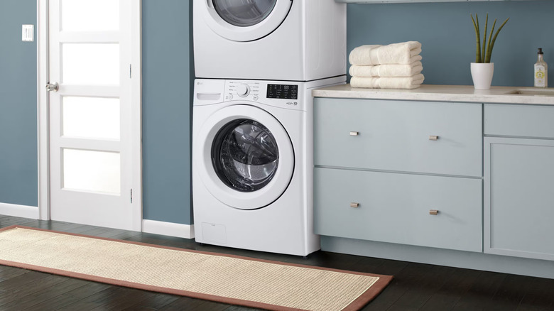 Stacked LG washer over dryer in minimalist modern laundry room