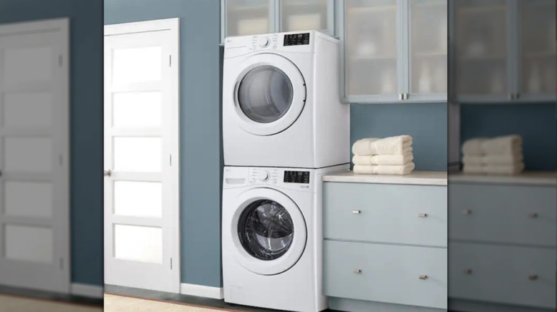 Stacked LG washer over dryer in minimalist modern laundry room